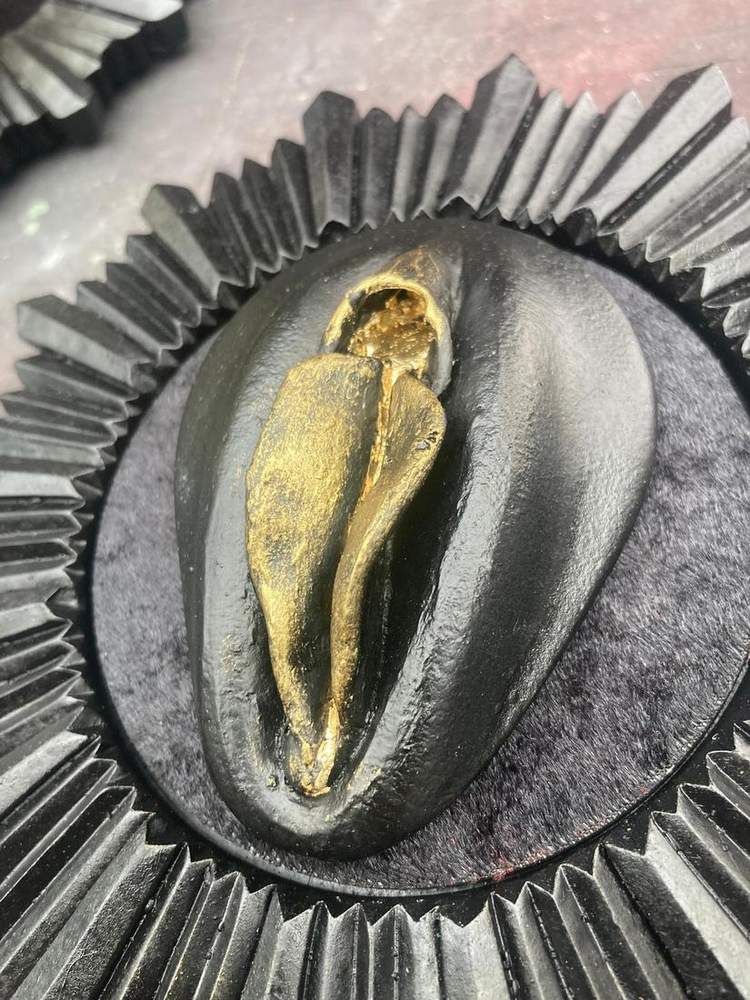Gold leafed specimen on a black tray