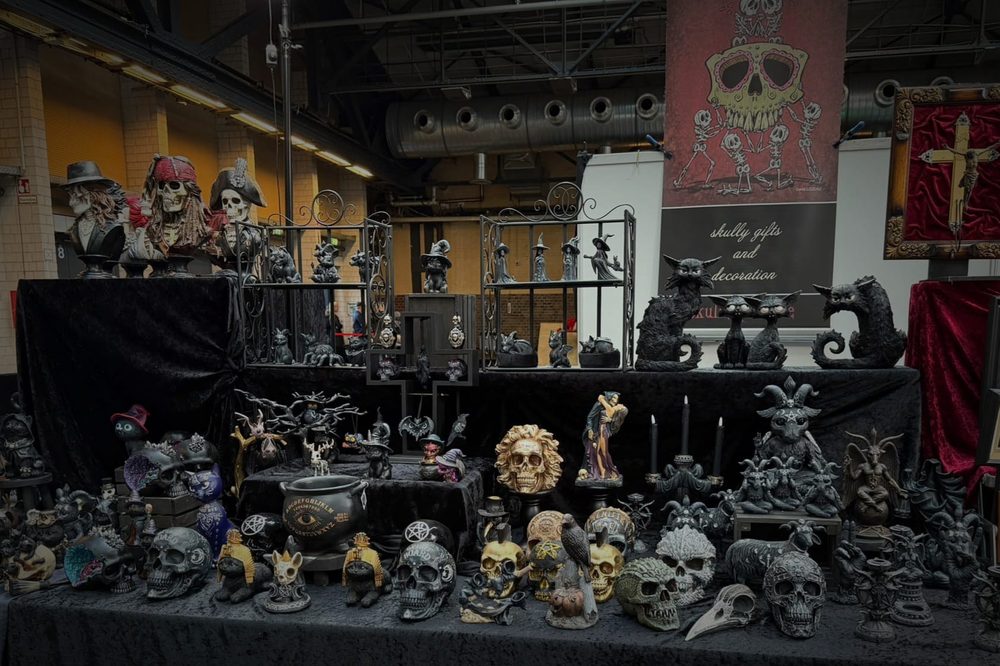 Black table of skulls, cats and witches under the skully gifts banner